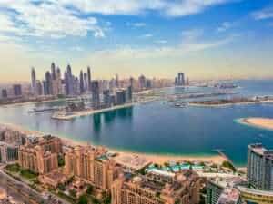 Yacht sailing in Dubai with scenic views of the coastline.